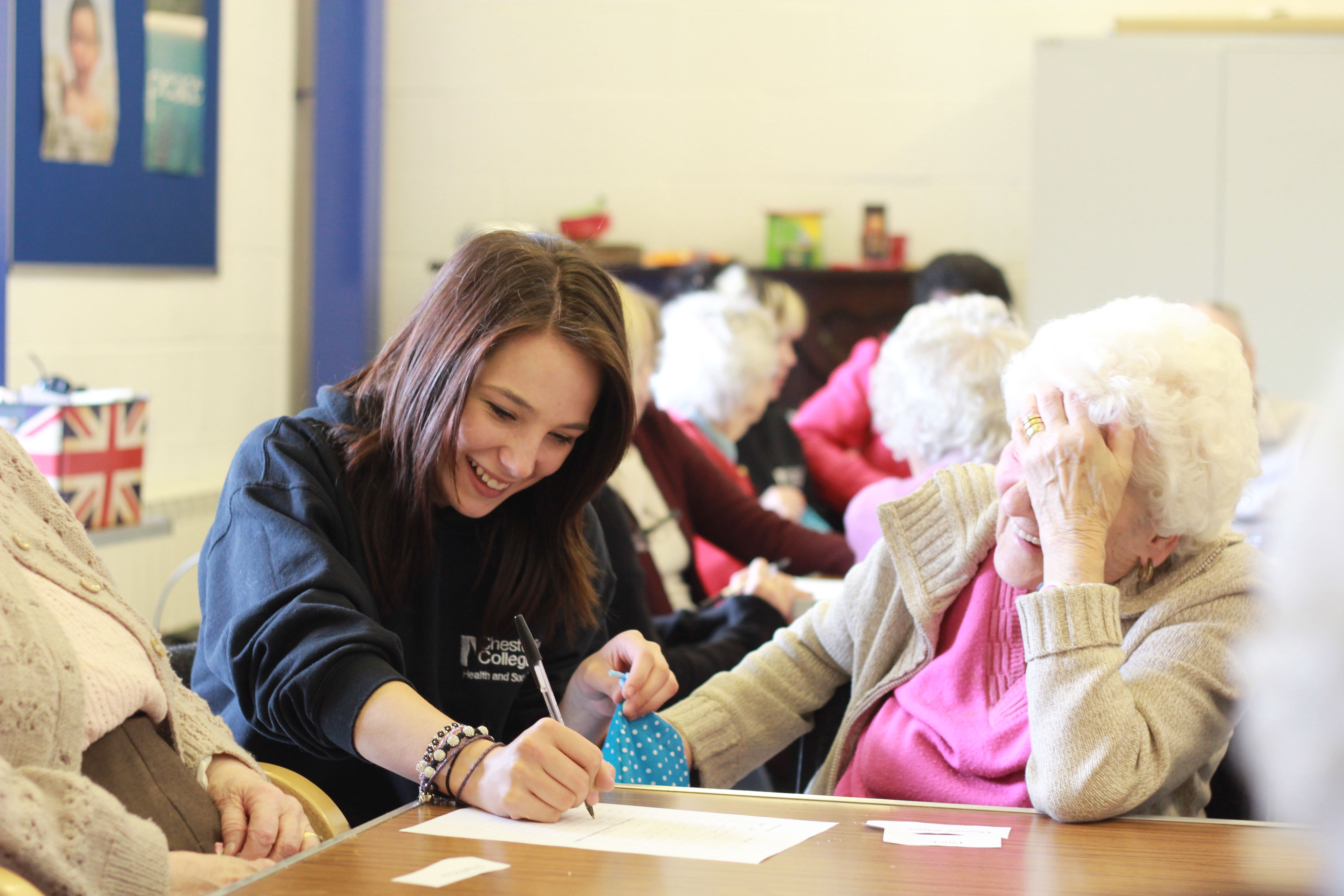 Carer laughing with a care resident