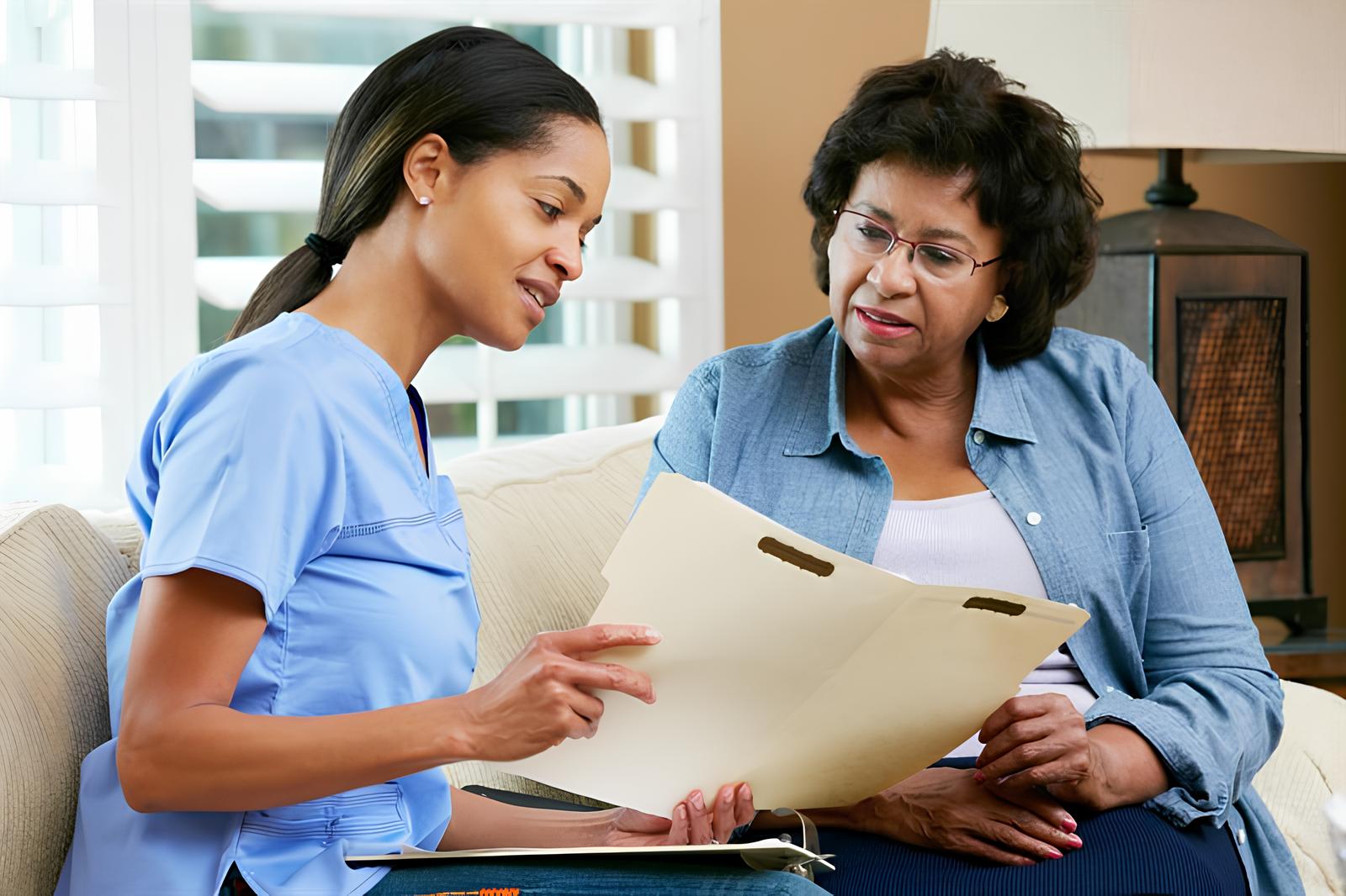 Nursing Associate showing a document to a patient
