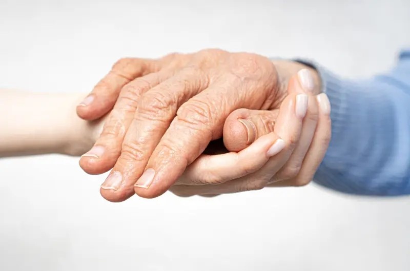 Caregiver assisting elderly resident